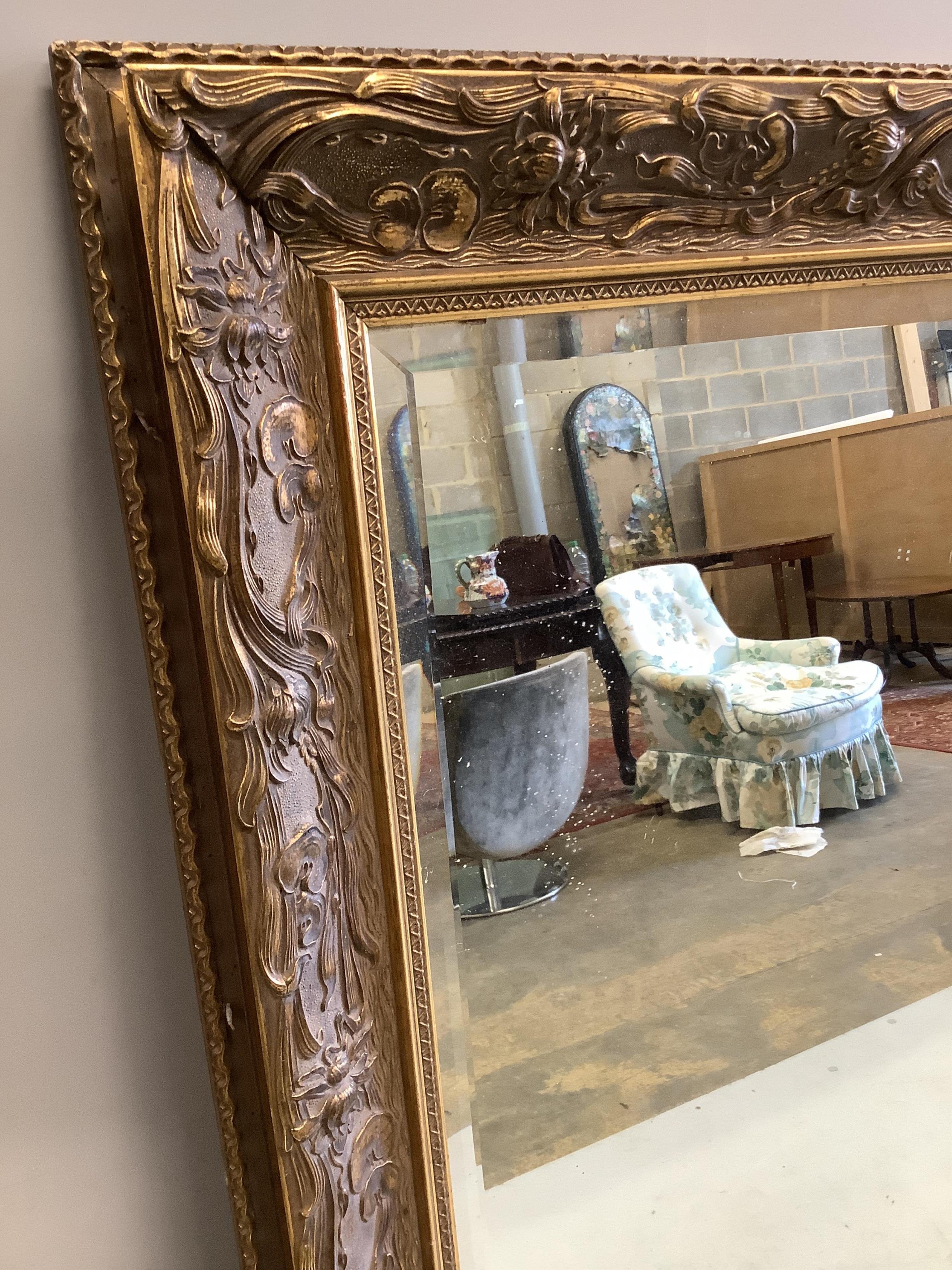 A reproduction Art Nouveau style rectangular wall mirror, width 122cm, height 182cm. Condition - good